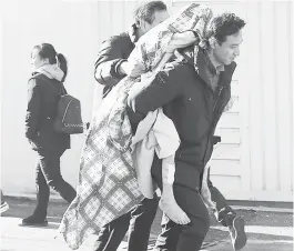  ?? (AP) ?? ‘DEADLIEST BLAZE.’ A person injured in a fire is carried from a hospital in Miryang, South Korea, Friday. The hospital fire causes scores of casualties and injuries, according to a fire agency official.