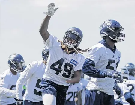  ?? TED S. WARREN/AP ?? Shaquem Griffin (49), who could get more time at strongside linebacker for the Seahawks, goes through a drill during minicamp at the team’s training facility in Renton, Washington.