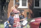  ?? KAREN PULFER FOCHT/THE COMMERCIAL APPEAL ?? Iresha Wilkens took her children Makyla and Lil Lloyd Jordan out of Westside Elementary School on Thursday. “They won’t be coming back here,” she said.