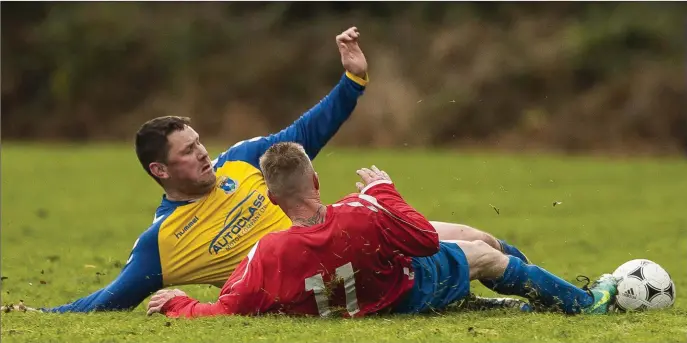  ?? Picture: Garry O’Neill ?? Wicklow Town’s David ‘Doc’ O’Connor and Conary’s Jimmy Davis slide in on each other during the Wicklow Cup in Rooster Park, Avoca.