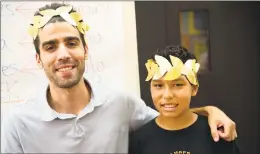  ?? Courtesy of Family & Children's Agency ?? Staff member Chris Cenatiempo takes a photo with an ASPIRE camper with their Roman crowns during summer camp at Family &amp; Children’s Agency.