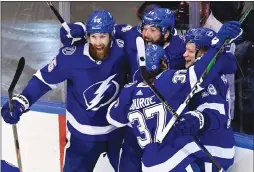  ?? The Canadian Press ?? Tampa Bay Lightning forward Ondrej Palat (18) celebrates with his teammates after scoring the winning overtime goal against Boston on Tuesday.