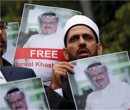  ?? PHOTO: REUTERS ?? Missing: Friends of journalist Jamal Khashoggi hold his pictures during a protest outside the Saudi consulate London. in