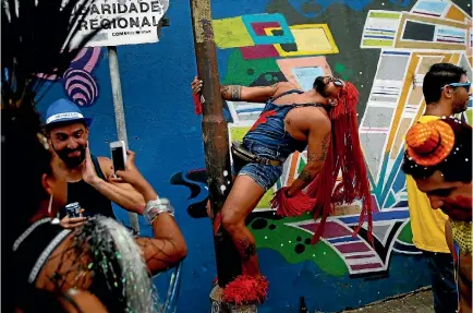  ?? PHOTO: REUTERS ?? Revellers take part in an annual block party known as ‘‘Ceu na Terra’’ (Heaven on Earth), one of the many carnival parties to take place in the neighbourh­oods of Rio de Janeiro.