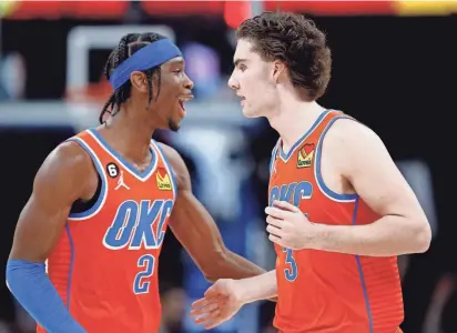  ?? SARAH PHIPPS/THE OKLAHOMAN ?? Shai Gilgeous-Alexander (2) congratula­tes Josh Giddey (3) on his 3-point basket in the fourth quarter of a game between the Oklahoma City Thunder and the Dallas Mavericks on Jan.8.