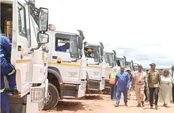  ?? ?? Transport and Infrastruc­tural Developmen­t Minister Felix Mhona (second from right) and Mashonalan­d West Minister of State for Provincial Affairs and Devolution Marian Chombo (right) and other Government officials inspect trucks and equipment during the ground-breaking ceremony for the rehabilita­tion and widening project for the Harare-Chirundu highway yesterday