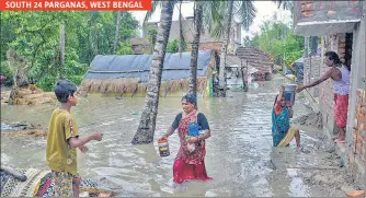  ??  ?? Villagers wade through a waterlogge­d and muddy road in a village in South 24 Paraganas, West Bengal; and water enters through the boundary of a house in Chandipur area of Balasore, Odisha on Wednesday. SOUTH 24 PARGANAS, WEST BENGAL