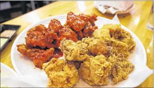  ?? AP PHOTO ?? Korean-style fried chicken sits waiting to be eaten at a restaurant in Edmonds, Wash.