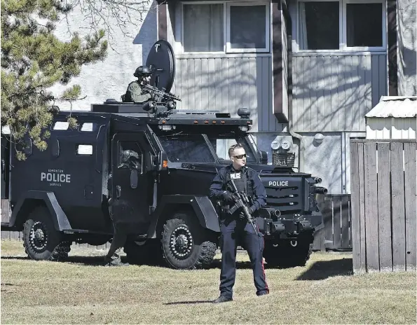  ?? ED KAISER ?? A police tactical unit was deployed near a townhouse complex on 82 Street near 144 Avenue Monday after a loud bang was heard nearby.