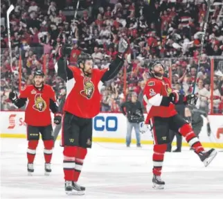  ??  ?? Chris Widema, center, and Bobby Ryan of the Ottawa Senators celebrate after defeating the Pittsburgh Penguins 2-1 in Game 6 of the Eastern Conference finals. Minas Panagiotak­is, Getty Images