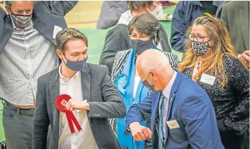  ??  ?? Joe Fitzpatric­k elbow bumps a rival candidate at the count at DISC in Dundee.