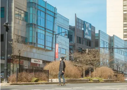  ?? ?? Above, a pedestrian crosses Trumbull Street near the XL Center in Hartford on Thursday. AARON FLAUM/HARTFORD COURANT