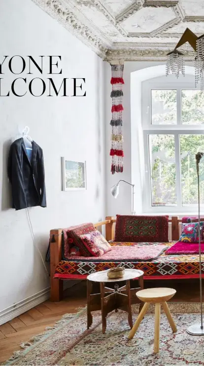  ??  ?? Living room An Iranian takht or daybed takes the place of a sofa in this space.
In front of it are a vintage three-legged Romanian stool and an Ottoman side table/tea tray. A Persian kilim and vintage rug cover the floor. The sideboard is a mid-century Polish design that owner Kasia inherited from her family and the chair was made by Polish woodworker­s. Placed on the shelf between the windows is Man With the
Head of Dog, a sculpture by Janek Simon