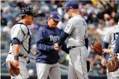  ?? Associated Press ?? ■ Tampa Bay Rays catcher Wilson Ramos, left, watches as Rays' manager Kevin Cash, center, takes the ball from Rays starting pitcher Blake Snell in the fourth inning of a baseball game against the New York Yankees on Wednesday in New York.