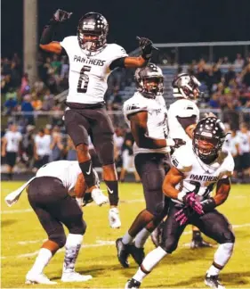  ?? STAFF FILE PHOTO BY DOUG STRICKLAND ?? Ridgeland players celebrate Shawn Wilson’s (24) intercepti­on during their 2017 game against Heritage at Heritage High School in Ringgold, Ga.