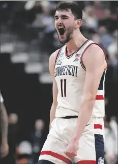  ?? JOHN LOCHER/AP ?? UCONN’S ALEX KARABAN (11) celebrates in the first half of a Sweet 16 college basketball game against Arkansas in the West Regional of the NCAA Tournament on Thursday in Las Vegas.