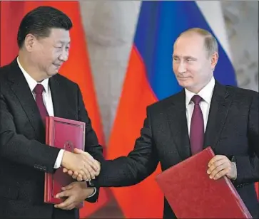  ?? Alexander Nemenov AFP/Getty Images ?? CHINESE PRESIDENT Xi Jinping and Russian counterpar­t Vladimir Putin, pictured at the Kremlin in July 2017, are both avowed nationalis­ts who gained power through patient, skilled political maneuverin­g.