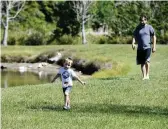  ?? TIFFANY TOMPKINS ttompkins@bradenton.com ?? A father and his son enjoy the day near their home in the evacuation zone surroundin­g Piney Point in Manatee County on Sunday.