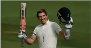  ?? PHOTO BY MIKE HEWITT ?? England’s Zak Crawley raises his bat and helmet to celebrate scoring a century during the first day of the third cricket Test match between England and Pakistan, at the Ageas Bowl in Southampto­n, England, Friday, Aug. 21.