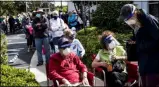  ?? ANDREW WEST ?? Joel and Susan Pittelman, from Naples, Fla., wait in line to receive COVID-19vaccines on Tuesday, Dec. 29, 2020, at East County Regional Library in Lehigh Acres, Fla.