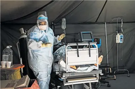  ?? JEROME DELAY/AP ?? COVID-19 patients are treated Friday at a hospital in Pretoria, South Africa. The country’s cases have doubled in two weeks.