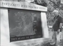  ?? Photo by Joseph B. Nadeau ?? Terry Nau, retired sports editor of The Call and The Times, looks over a memorial for the 21 Pawtucket men who were killed in the Vietnam War.