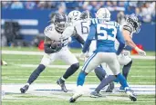  ?? DARRON CUMMINGS — THE ASSOCIATED PRESS ?? Tennessee Titans running back Derrick Henry (22) cuts away from Indianapol­is Colts outside linebacker Darius Leonard (53) in the first half Sunday in Indianapol­is.