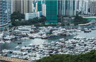  ?? JUSTIN CHIN / BLOOMBERG ?? A plethora of yachts and boats jam-pack a marina in Hong Kong. With substantia­l growth anticipate­d for the yacht industry in the coming years, cross-boundary yacht travel promises new opportunit­ies for the city’s pleasure-boat business.