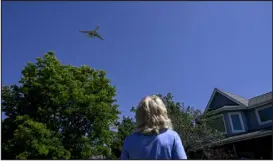  ?? AARON ONTIVEROZ — DENVER POST FILE ?? Charlene Willey watches a plane fly over her home in Westminste­r on June 26. Willey, who built the home with her late husband in 1994, said that as the area has grown so has the amount of traffic at Rocky Mountain Metropolit­an Airport.