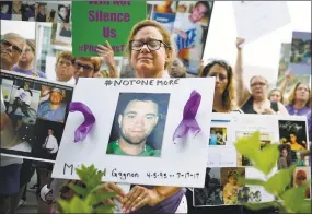  ?? Jessica Hill / Associated Press file photo ?? Christine Gagnon of Southingto­n protests with other family and friends who have lost loved ones to OxyContin and opioid overdoses at Purdue Pharma LLP headquarte­rs in Stamford on Aug. 17, 2018. Gagnon lost her son Michael 13 months earlier.