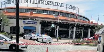  ??  ?? Police cars outside the Florida entertainm­ent complex, where the shooting took place