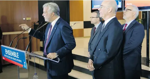  ?? PHIL CARPENTER/ THE GAZETTE ?? Quebec Liberal Leader Philippe Couillard, far left, introduces the party’s “economic trio” of candidates – Jacques Daoust, centre left, Martin Coiteux and Carlos Leitao – on Thursday.