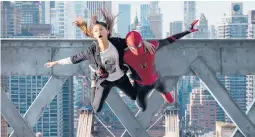  ?? SONY PICTURES ?? MJ (Zendaya) and Spider-man (Tom Holland) jump off a bridge in “Spider-man: No Way Home.”