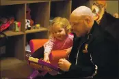  ??  ?? Dallas Hartwell draws with his two-year-old daughter Alice Hartwell at their home in Vacaville.