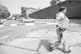  ??  ?? A Texas Department of Criminal Justice officer closes the road in front of the Huntsville Unit before protesters demonstrat­e against Young’s execution.