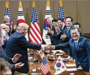  ?? DOUG MILLS / THE NEW YORK TIMES ?? President Donald Trump shakes hands with President Moon Jae-In of South Korea during a bilateral meeting at the Blue House, the presidenti­al residence in Seoul, last year. Moon is working toward a peace agreement with North Korea.