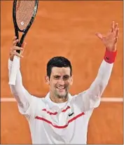  ?? Anne-Christine Poujoulat NOVAK DJOKOVIC AFP via Getty Images ?? smiles after advancing to the French Open’s round of 16 for the 11th straight year.