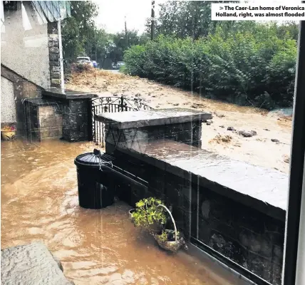  ??  ?? > The Caer-Lan home of Veronica Holland, right, was almost flooded