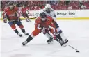  ?? ALEX BRANDON/ASSOCIATED PRESS ?? Capitals defenseman Michal Kempny, front, skates with the puck with Lightning center Cedric Paquette behind him during Game 3 of the Eastern Conference finals Tuesday in Washington. The Lightning won 4-2, narrowing the series deficit to 2-1.