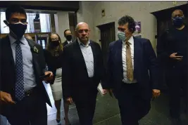  ?? JEFFERSON SIEGEL — THE NEW YORK TIMES ?? Allen Weisselber­g, center left, the former chief financial officer of the Trump Organizati­on, arrives to surrender at the Manhattan district attorney's office in New York in 2021.