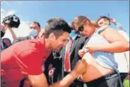  ?? AFP ?? Nine-time Australian Open champion Novak Djokovic signs on a pregnant woman’s belly during his trophy parade at the Brighton Beach in Melbourne on Monday.