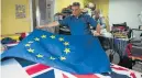  ?? Picture: AFP ?? LOSING POPULARITY: Flagmaker Andy Ormrod inspects a newly-produced EU flag.