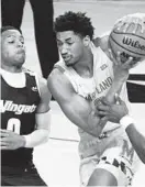  ?? THE BALTIMORE SUN KIM HAIRSTON/ ?? Wingate’s Jarren Cottingham, left, defends Maryland’s Aaron Wiggins during Friday’s game at Xfinity Center.