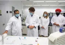  ??  ?? Prime Minister Justin Trudeau with Economic Developmen­t Minister Melanie Joly and Innovation, Science and Industry Minister Navdeep Bains speak about COVID-19 vaccines during a visit to the National Research Council facility in Montreal.