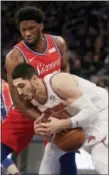  ?? SETH WENIG — THE ASSOCIATED PRESS ?? 76ers’ Joel Embiid, top, and Knicks’ Enes Kanter battle for a loose ball during Philadelph­ia’s victory over New York.