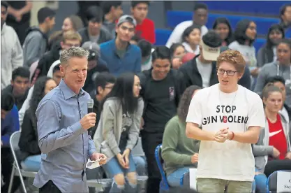  ?? PHOTOS BY ARIC CRABB— STAFF PHOTOGRAPH­ER ?? Golden State Warriors head coach Steve Kerr, left, and Matt Deitsch, right, a former student at Marjory Stoneman Douglas High School in Parkland, Fla., take part in a town hall meeting about gun violence at Newark Memorial High School on Monday.