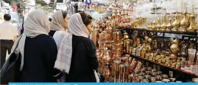  ?? — AFP ?? TEHRAN: Iranian women shop at Tehran’s ancient Grand Bazaar on Saturday.