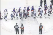  ?? JASON FRANSON - THE CANADIAN PRESS ?? Tampa Bay Lightning and the New York Islanders players shake hands after the Lightning won in overtime of Game 6 of the NHL hockey Eastern Conference final, Thursday, Sept. 17, 2020, in Edmonton, Alberta.