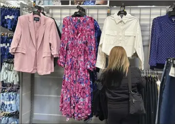  ?? ANNE D'INNOCENZIO — THE ASSOCIATED PRESS ?? A shopper looks at clothes at a Walmart store in Secaucus, N.J., on March 25. On Monday, the Commerce Department releases U.S. retail sales data for March