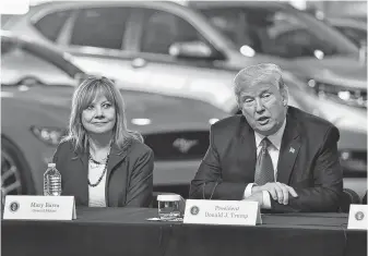  ?? Nicholas Kamm / AFP/Getty Images ?? President Donald Trump and General Motors CEO Mary Barra are now at odds, and he has threatened to cut GM subsidies after it announced layoffs in politicall­y crucial Midwest states.
